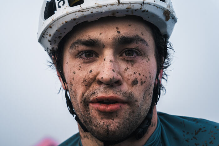 Portrait of a rider with a mud-spattered face after the finish
